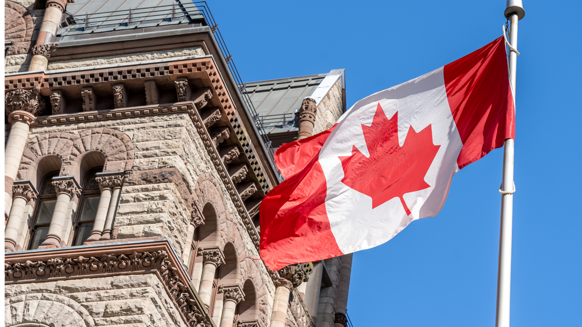 Canadian flag flying in front of Old City Hall in Toronto