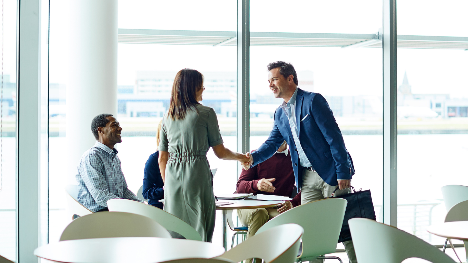 Business representatives greeting each other before a B2B matchmaking meeting