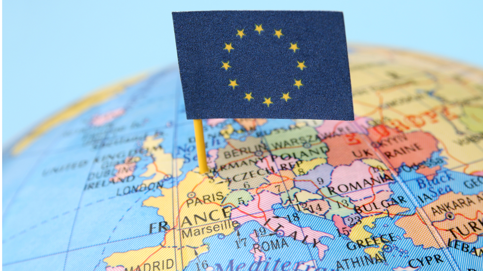 European Union flag pinned on a globe over Europe