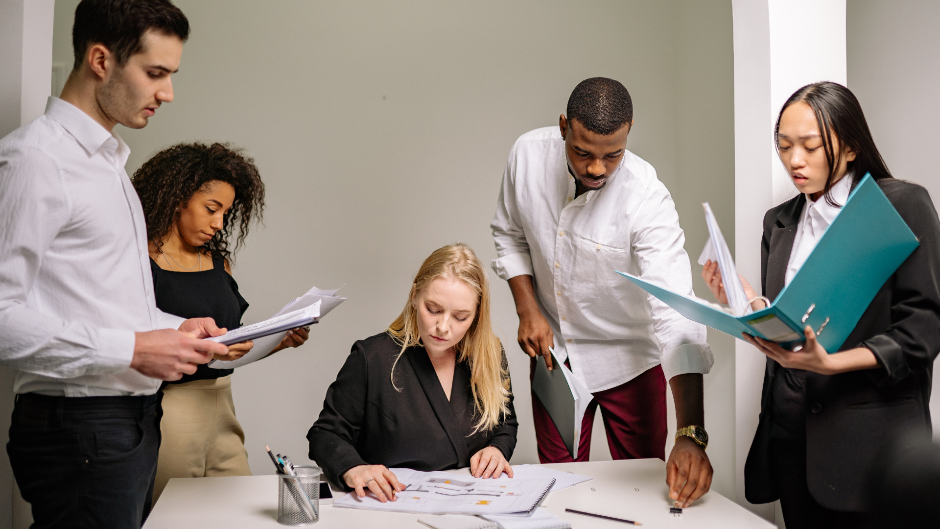 Investment promotion team reviewing documents for an investor proposal