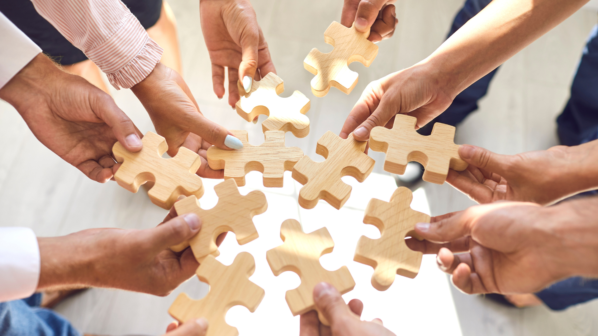Hands joining puzzle pieces, representing institutional coordination in investment facilitation