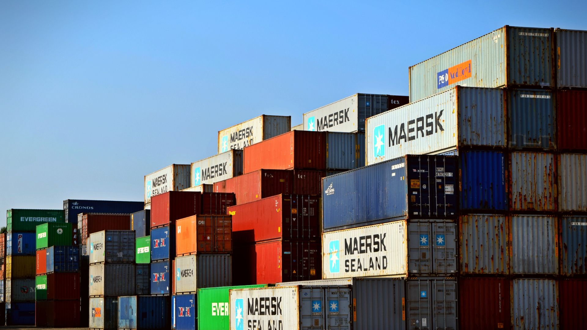 Shipping containers stacked at a port, representing the delivery capacity a new market requires